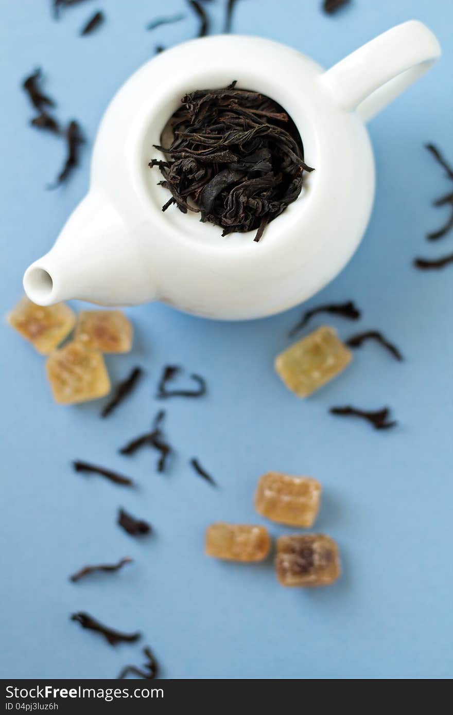 Small Tea Pot With Leaves Of Black Tea