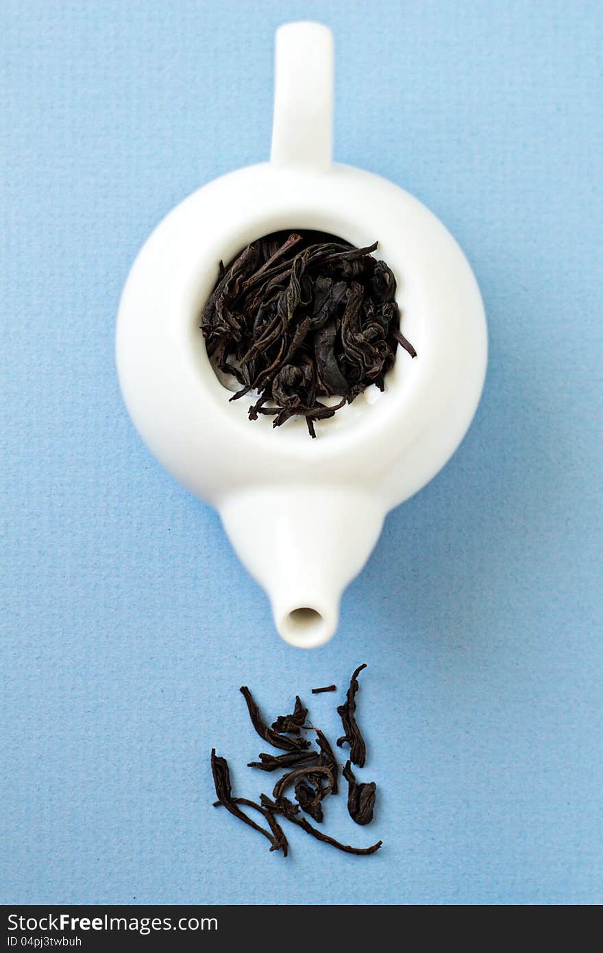 Small Tea Pot With Leaves Of Black Tea