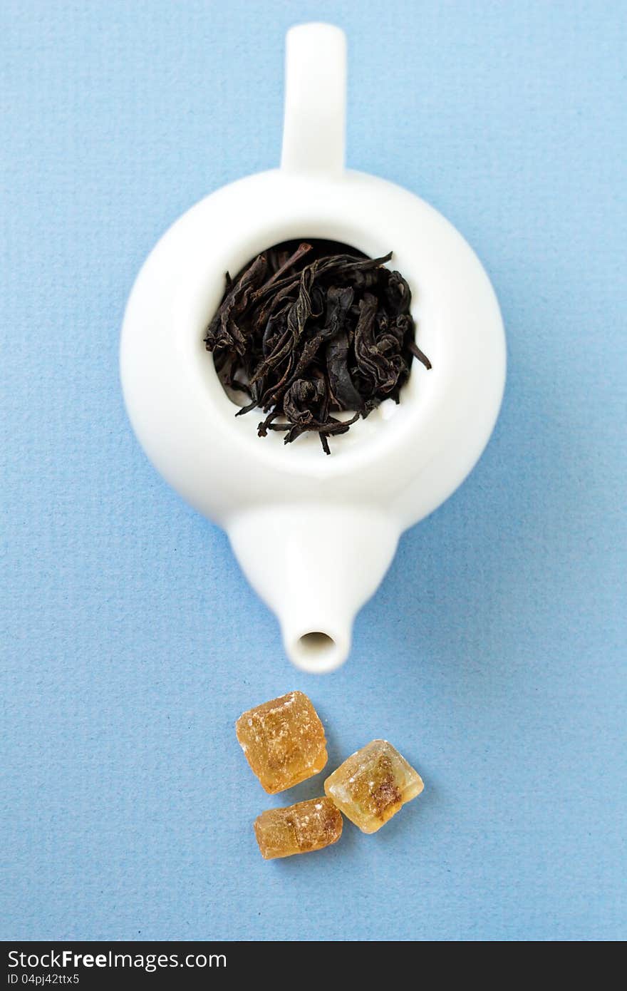 Small Tea Pot With Leaves Of Black Tea