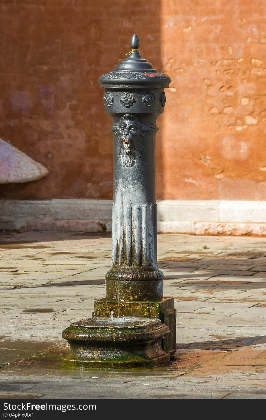 Ancient drinking spring on the square of the Italian city