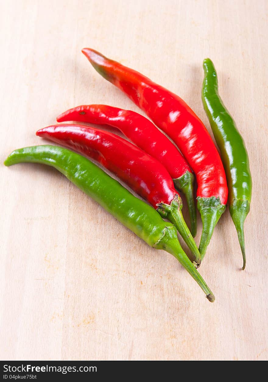 Red and green chili peppers on a white background