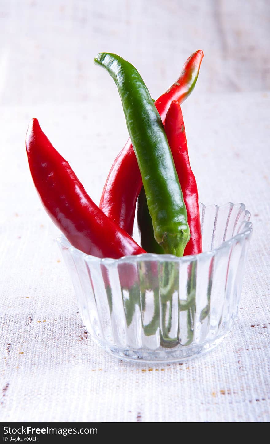 Red and green chili peppers in a glass. Red and green chili peppers in a glass