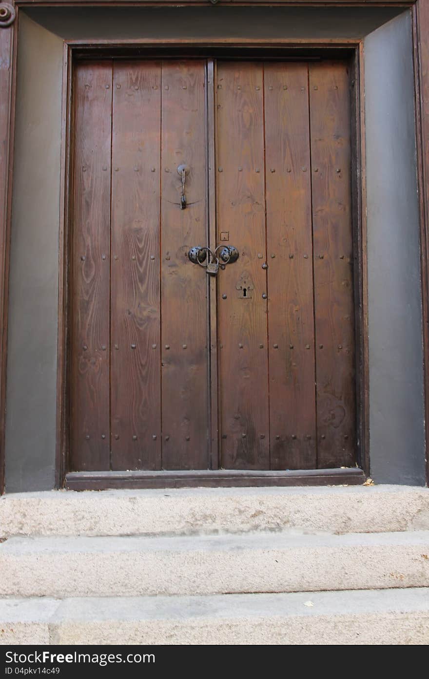 Wooden door with stone stairs in front of it