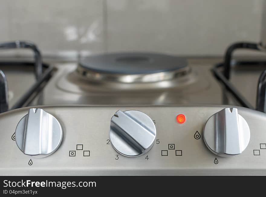 Electrical stove knob in kitchen work top with operation light on. Electrical stove knob in kitchen work top with operation light on