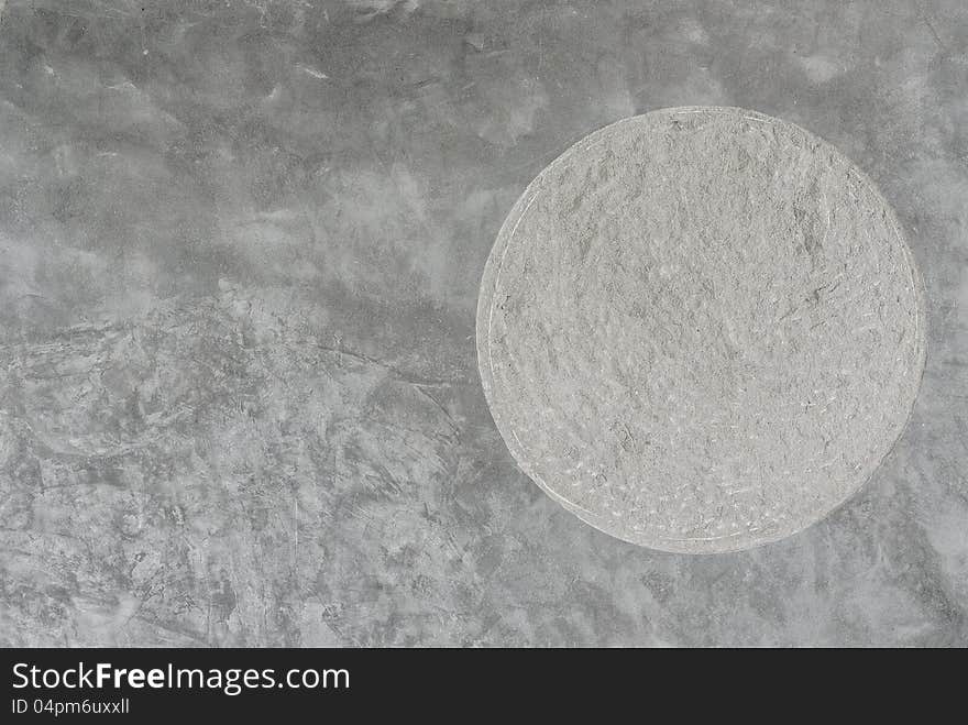 Plain cement wall with round rough texture insert