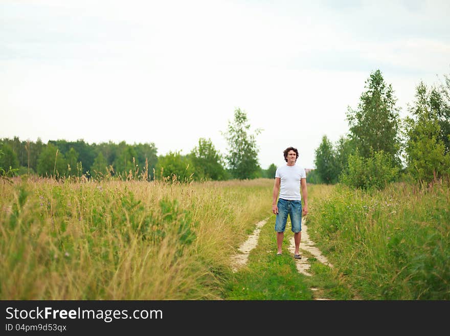 A man standing on a country road