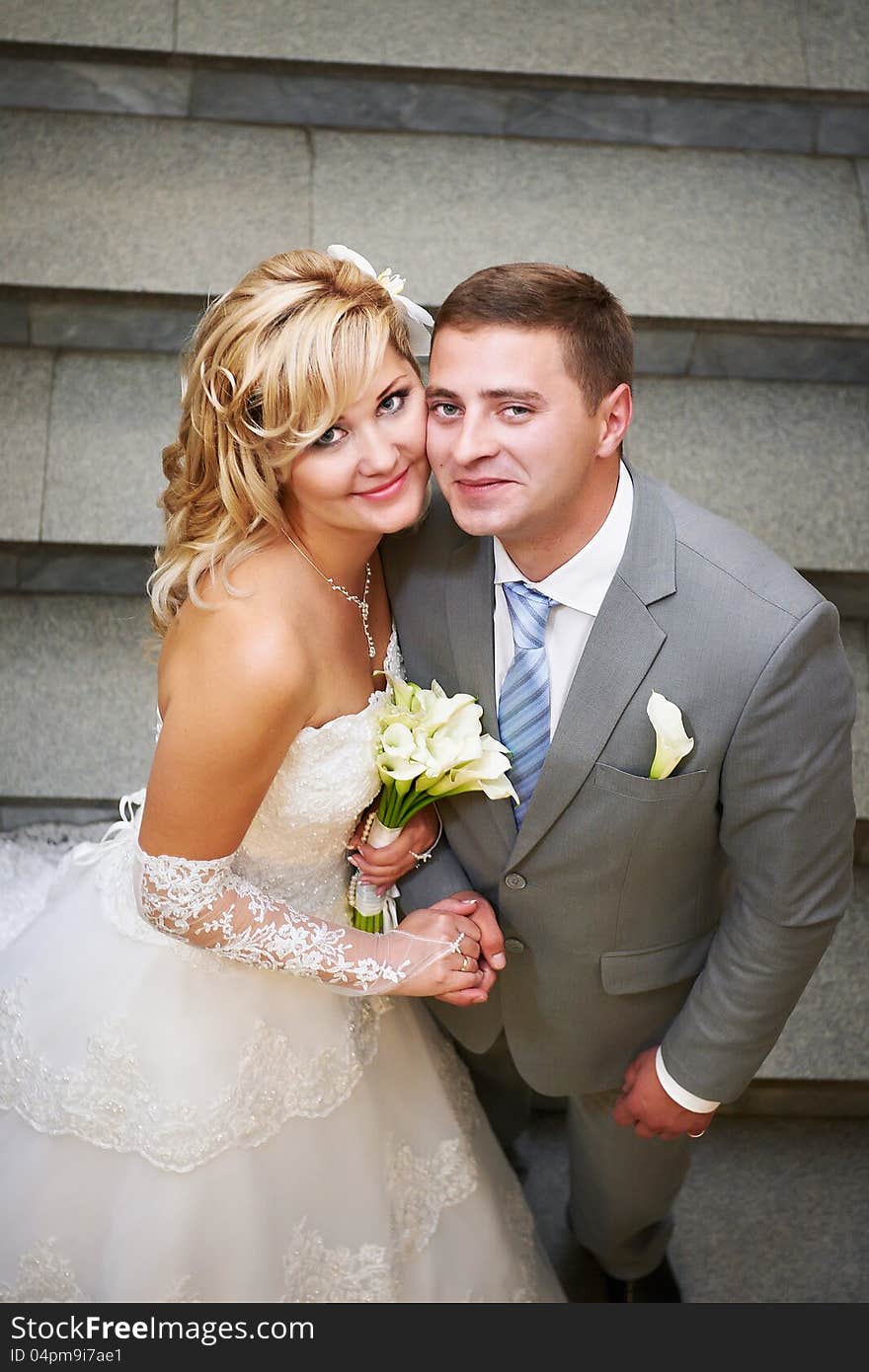 Happy bride and groom on the indoor stairs. Happy bride and groom on the indoor stairs