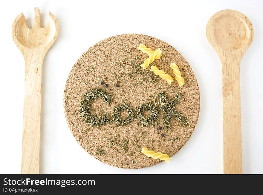 Wooden fork and spoon on meal set with wording Cook