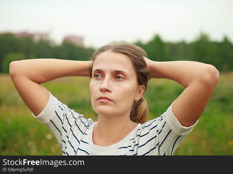 A young man sitting among flowering meadows. A young man sitting among flowering meadows.