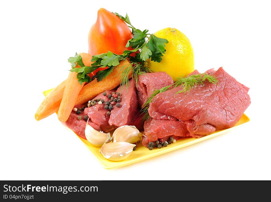 Vegetables with some spices and raw meat , on a white background. Vegetables with some spices and raw meat , on a white background