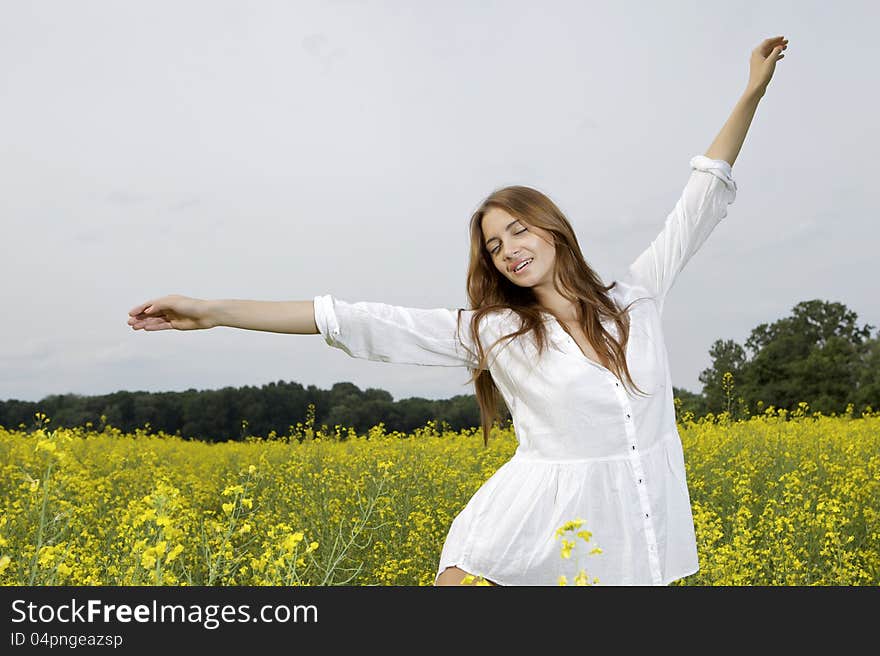 Brunette woman in a yellow flowers field