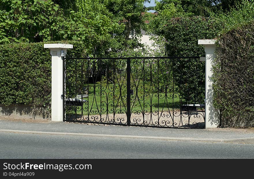 Beautiful black  gate, entrance to a front yard. Beautiful black  gate, entrance to a front yard