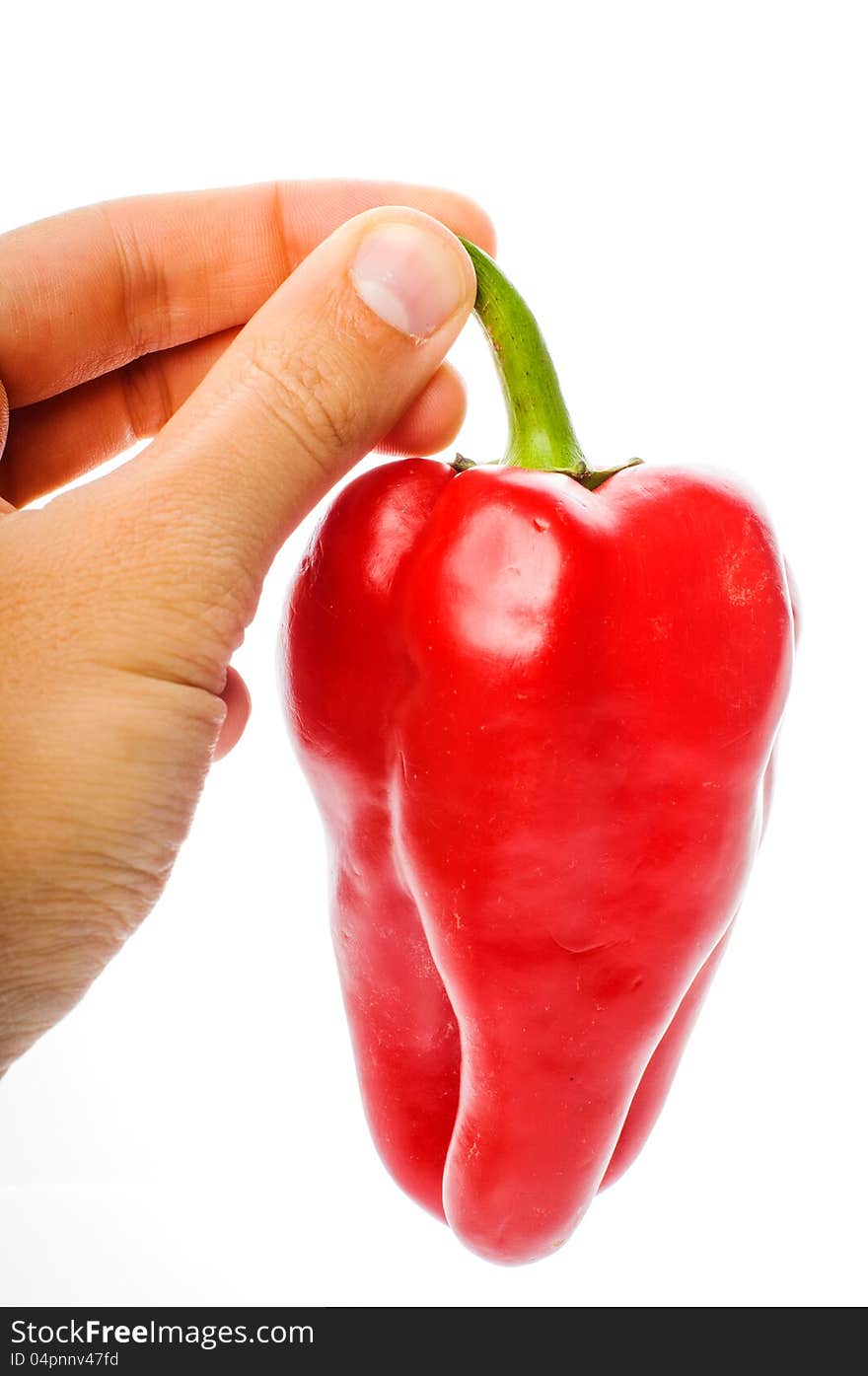 Hand with big red pepper