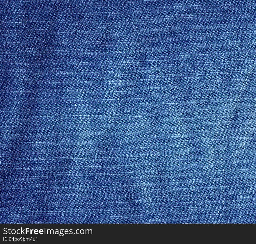 Crumpled blue jeans fabric texture. Crumpled blue jeans fabric texture