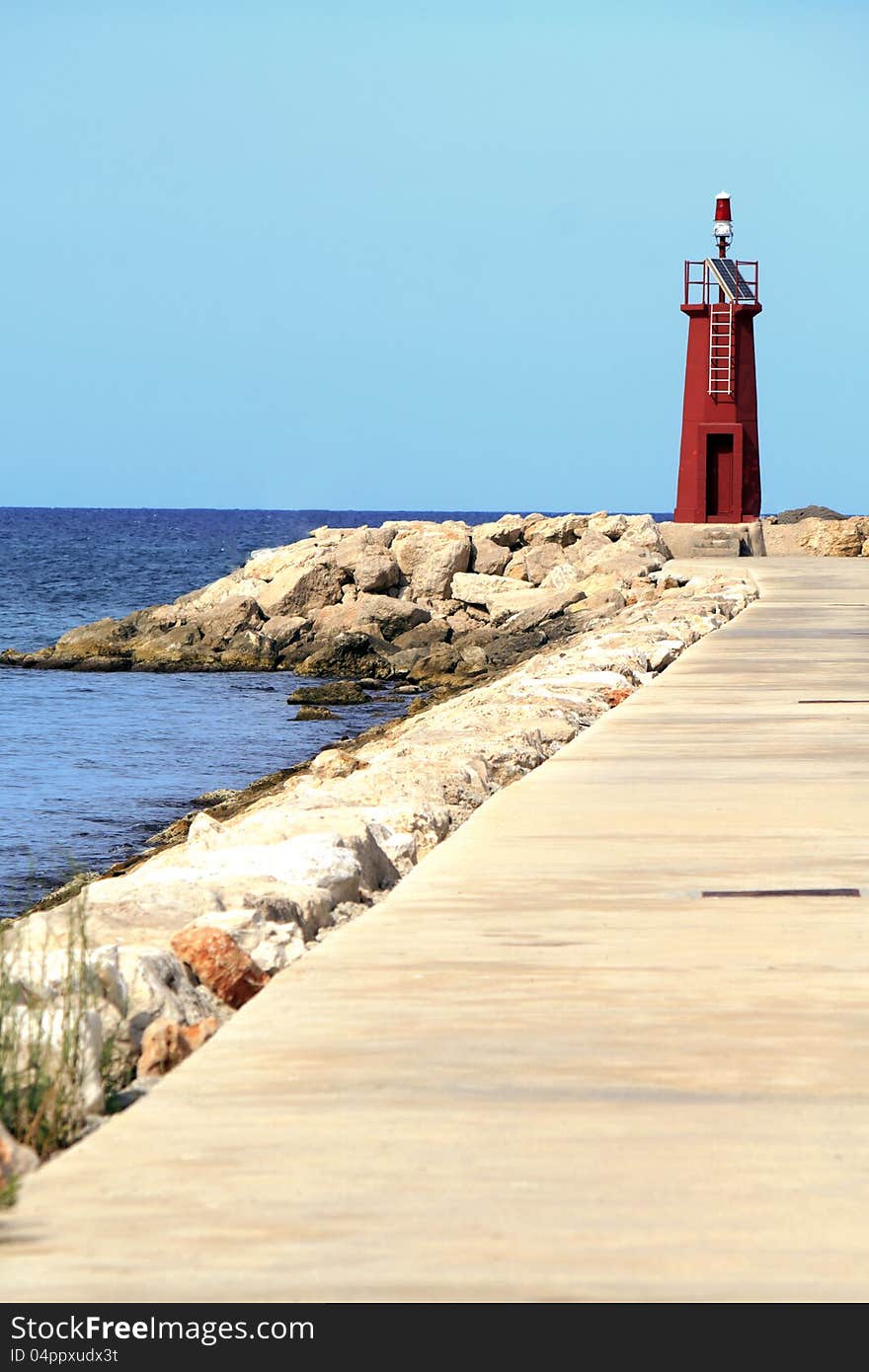 A lighthouse at the end of a marnia in Denia, Alicante Province of spain