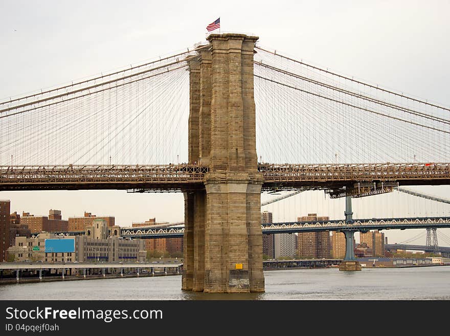 Vertical view of the first tower of the Brooklyn Bridge in Manhattan, New York. Vertical view of the first tower of the Brooklyn Bridge in Manhattan, New York