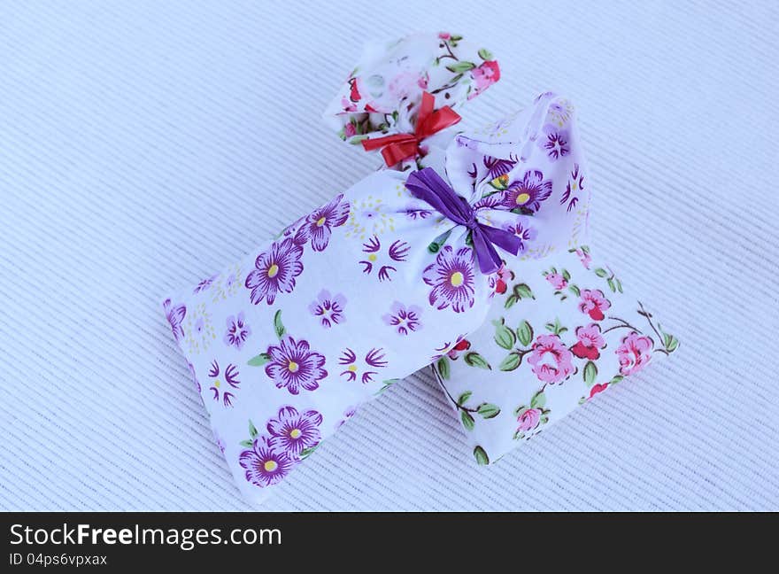 Two flower aroma bags on light background