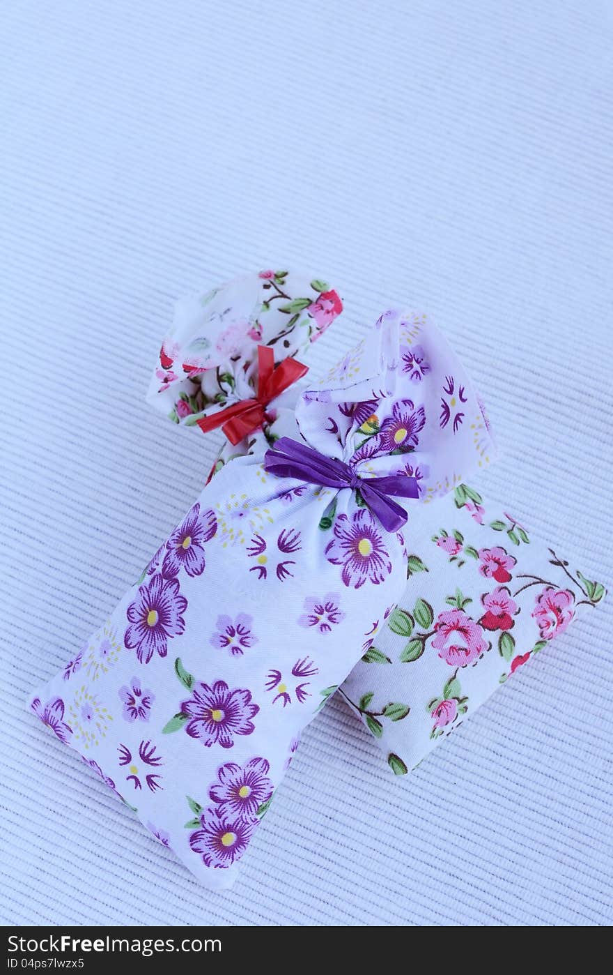 Two flower aroma bags on light background