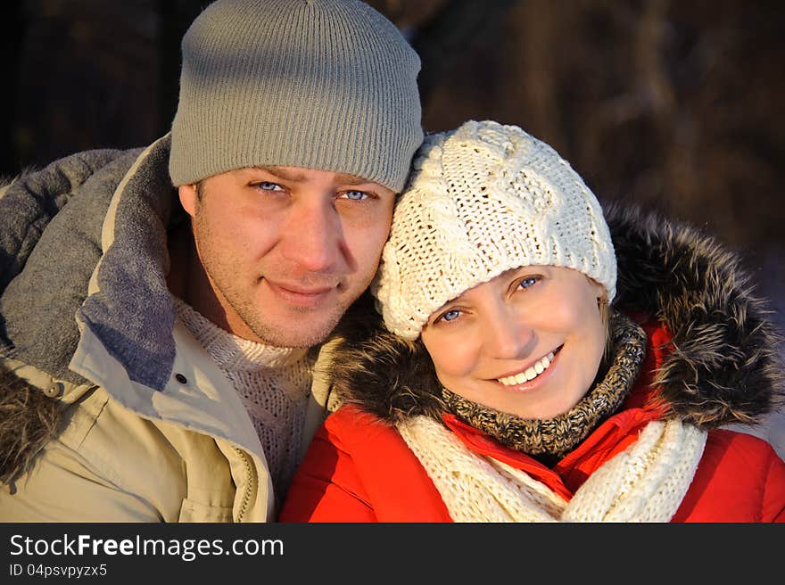 Portrait of women and her boyfriend in the winter park. Portrait of women and her boyfriend in the winter park.