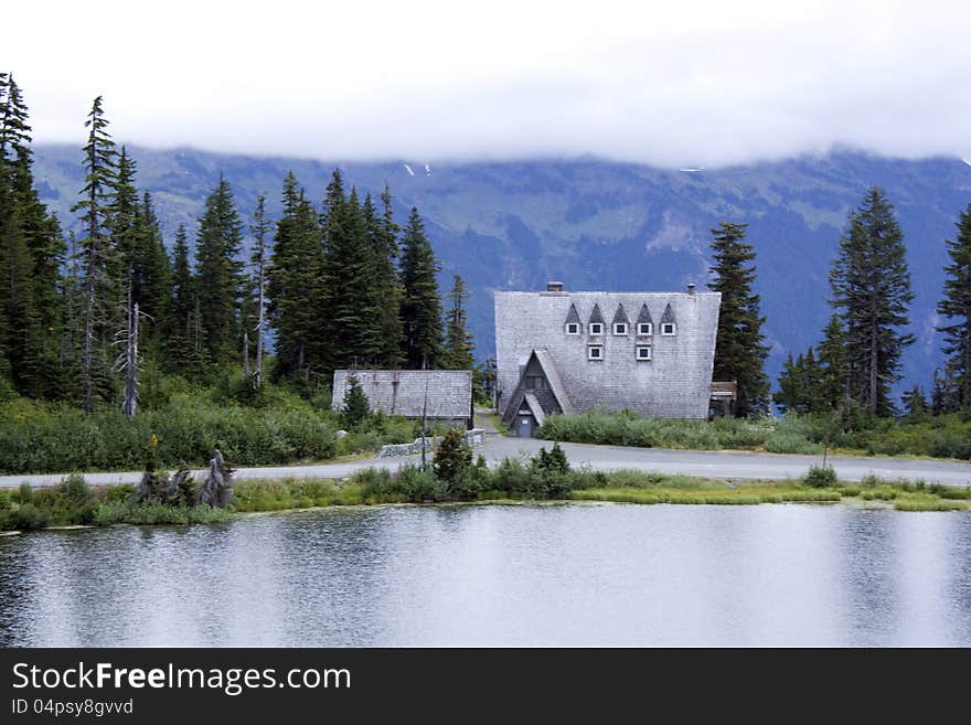 A church is on top of the high mountain with a lake in front. A church is on top of the high mountain with a lake in front.