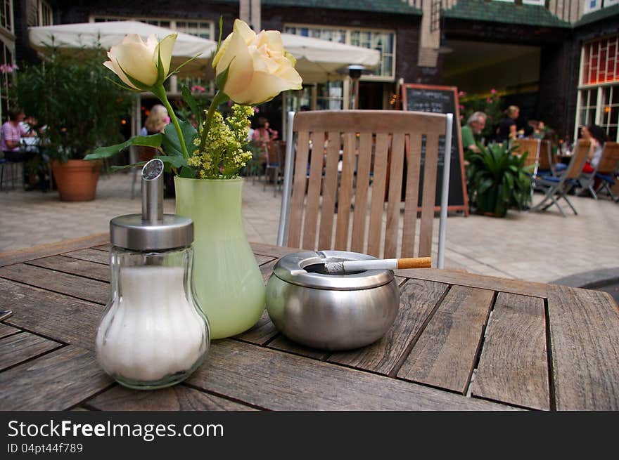 Table of bar with vase of flowers, ashtray and sugar bowl  outdoor;. Table of bar with vase of flowers, ashtray and sugar bowl  outdoor;