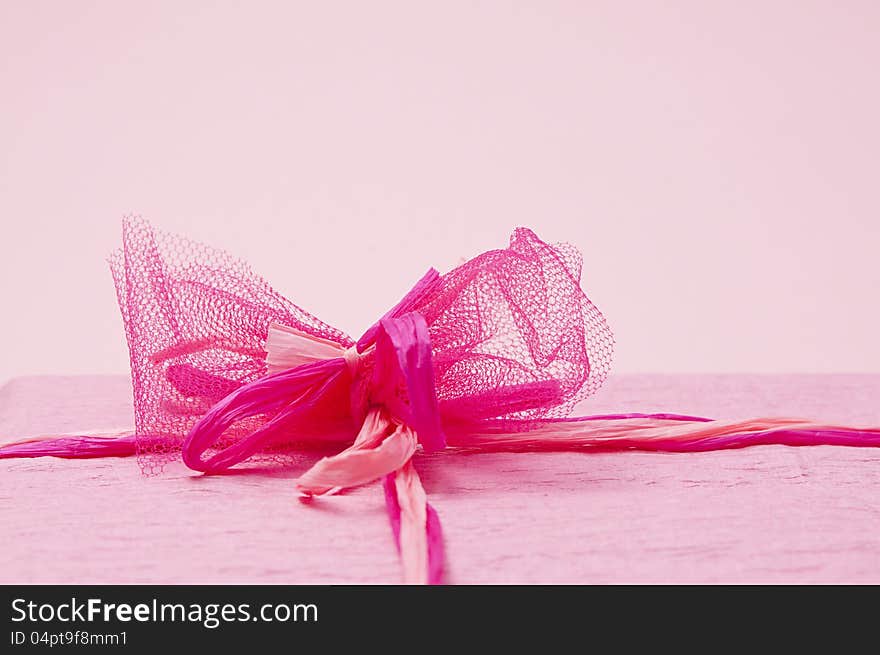 Pink color gift box with ribbon