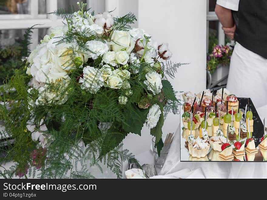 Flowers bouquet and tray canapes