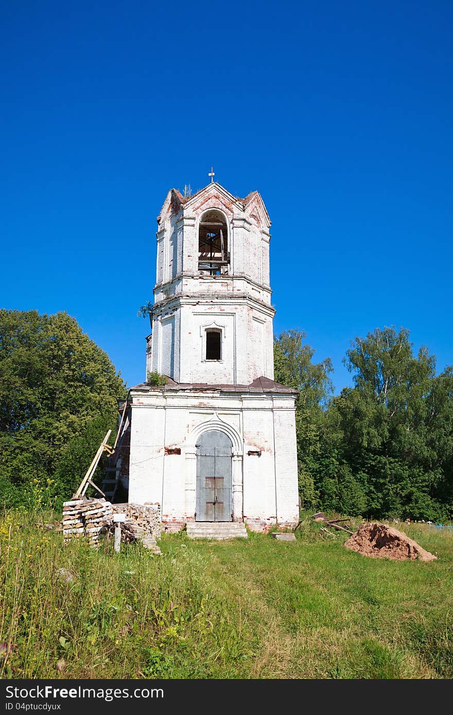 Old orthodox church against the clear blue sky and greenery.