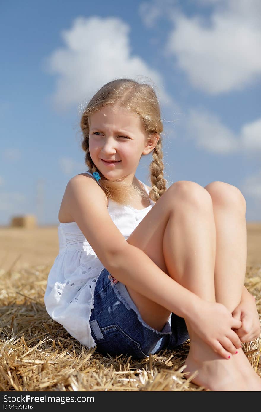 Blond girl on a haystack