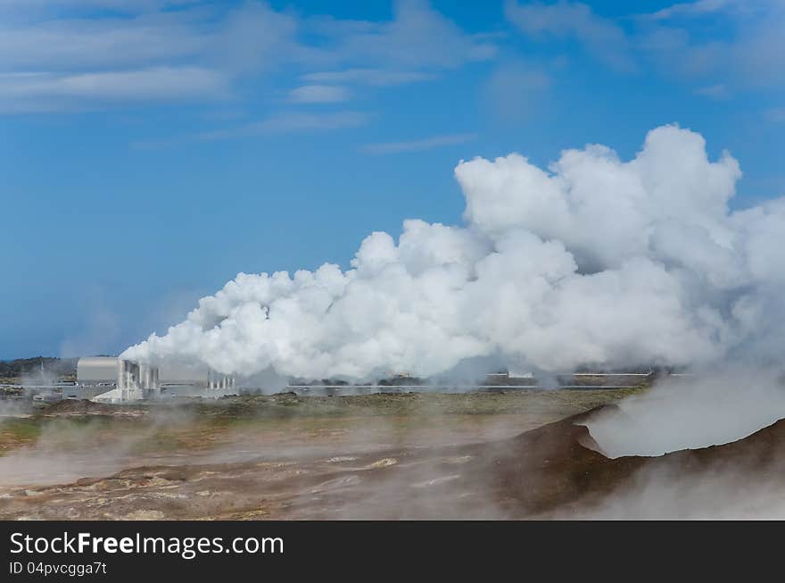 Smoking factory field polluting the air, blue sky background. Smoking factory field polluting the air, blue sky background