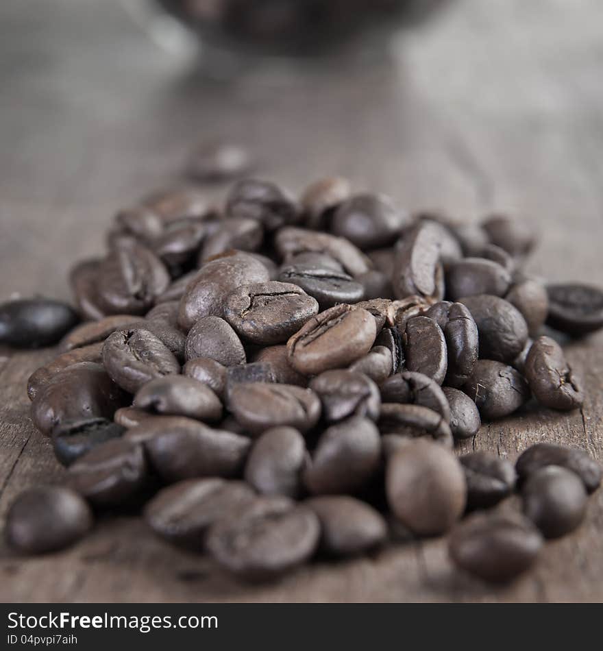 Close up of coffee beans on old wooden able