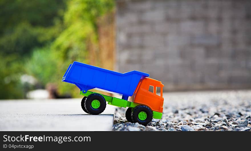 Color toy car on the gravel. Color toy car on the gravel.