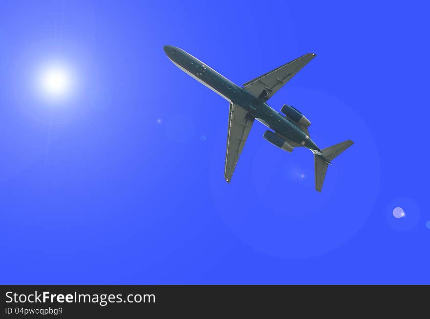 Airplane is flying through the sunlight. Airplane is flying through the sunlight