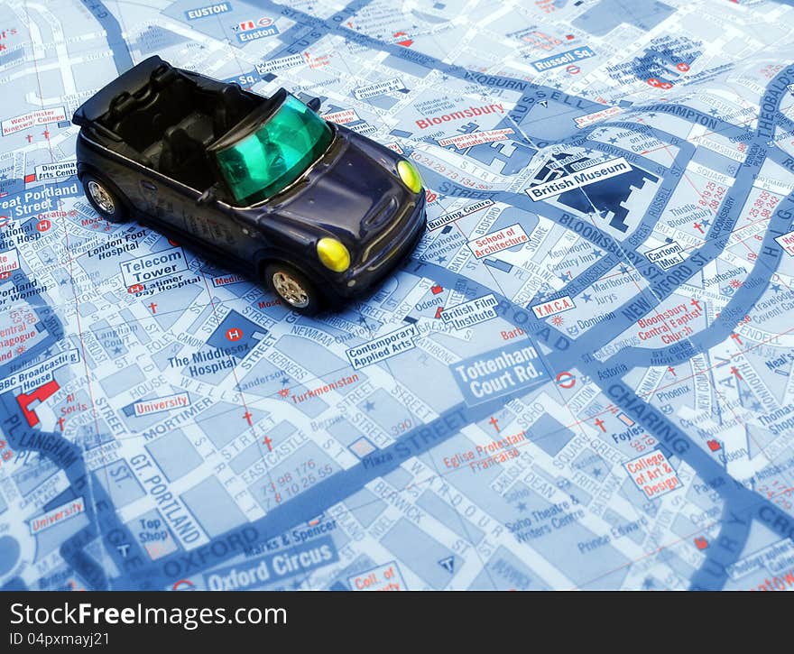 Convertible blue car over London map. Convertible blue car over London map