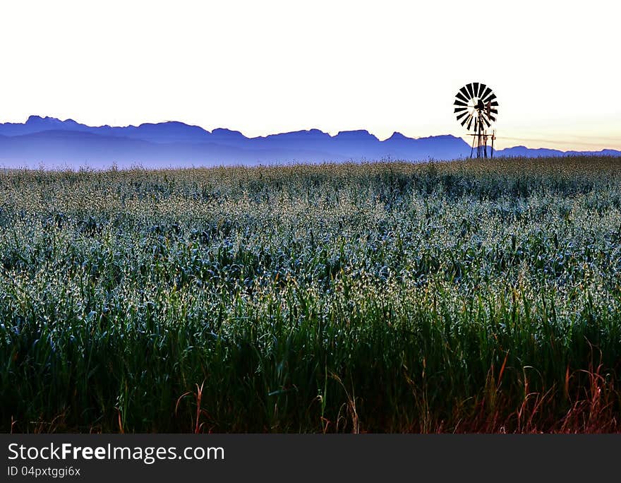 Landscape with windmill water pump at sunrise with ceres mountains