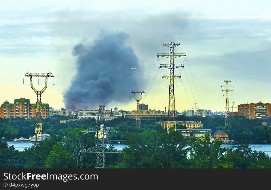 Cityscape with firestorm and fire-helicopter