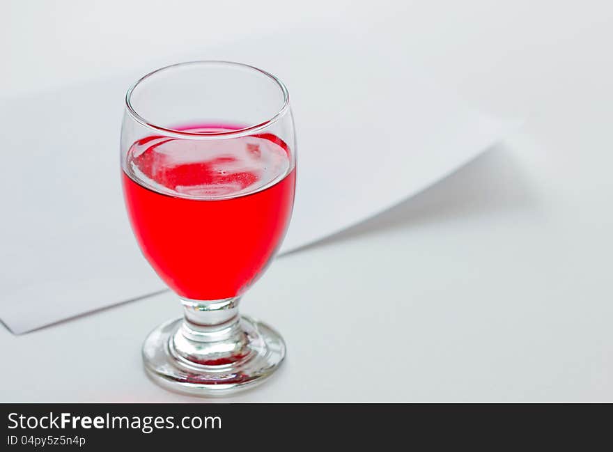 Red color, soft drink in glass with paper backgrou