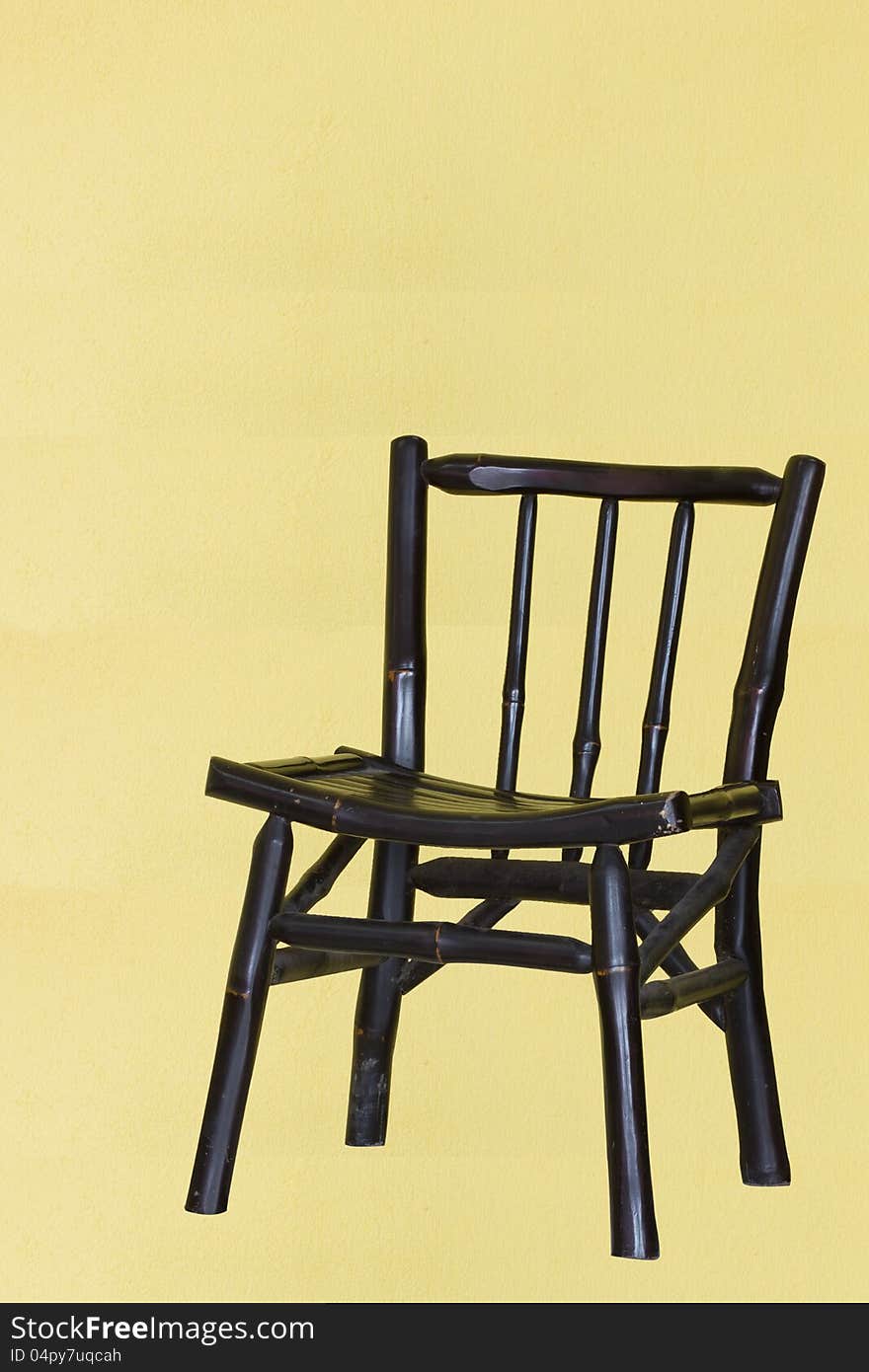 A traditional chair with yellow background and sha