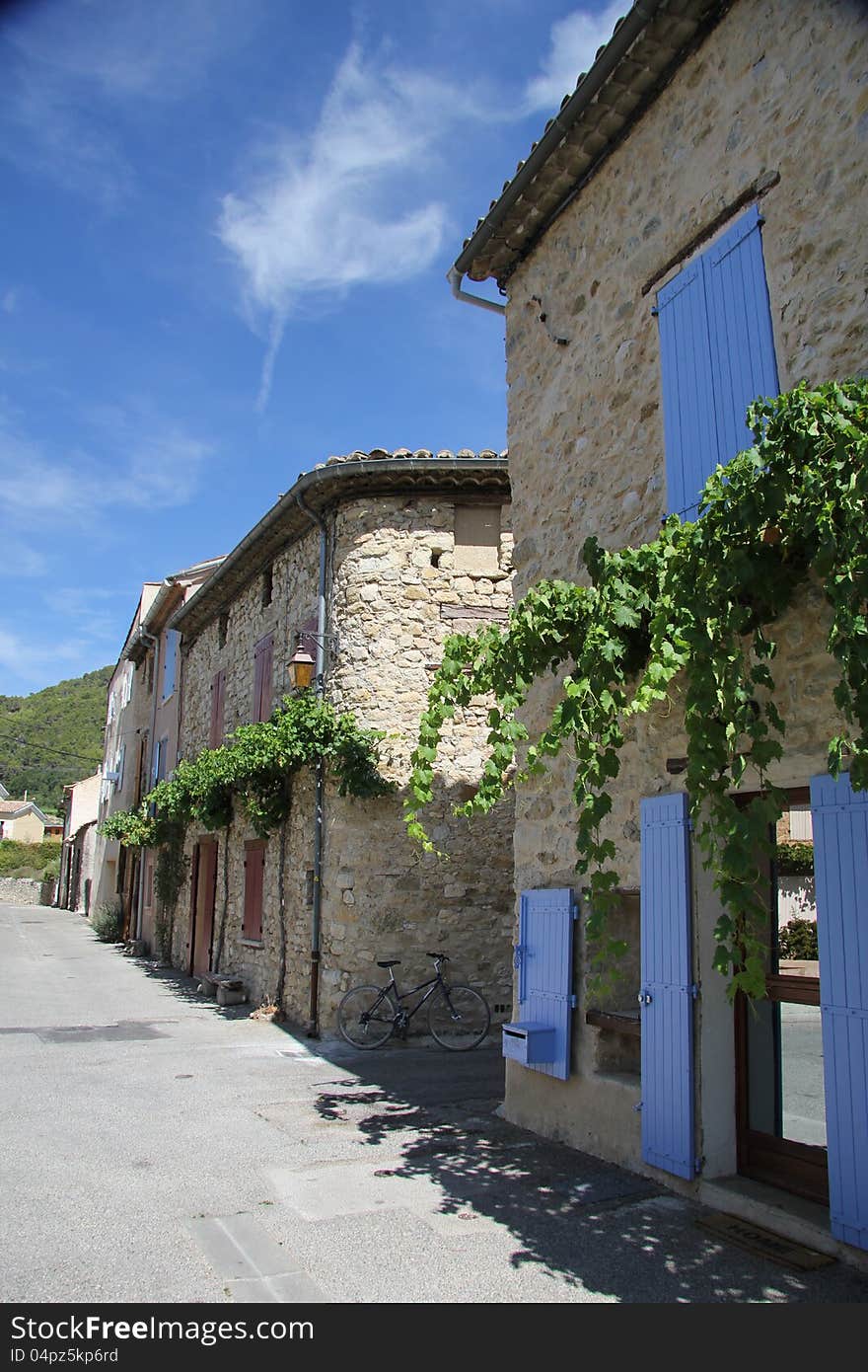 Traditional built houses with doors painted in bright colors in the French Provence. Traditional built houses with doors painted in bright colors in the French Provence