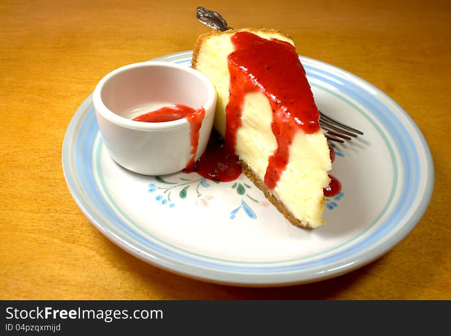 Cheesecake with strawberry glaze on table. Cheesecake with strawberry glaze on table.