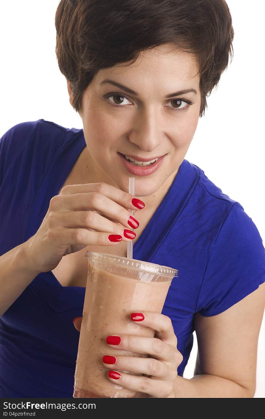 Beautiful woman with manicured nails sips a neutral colored smoothie. Beautiful woman with manicured nails sips a neutral colored smoothie