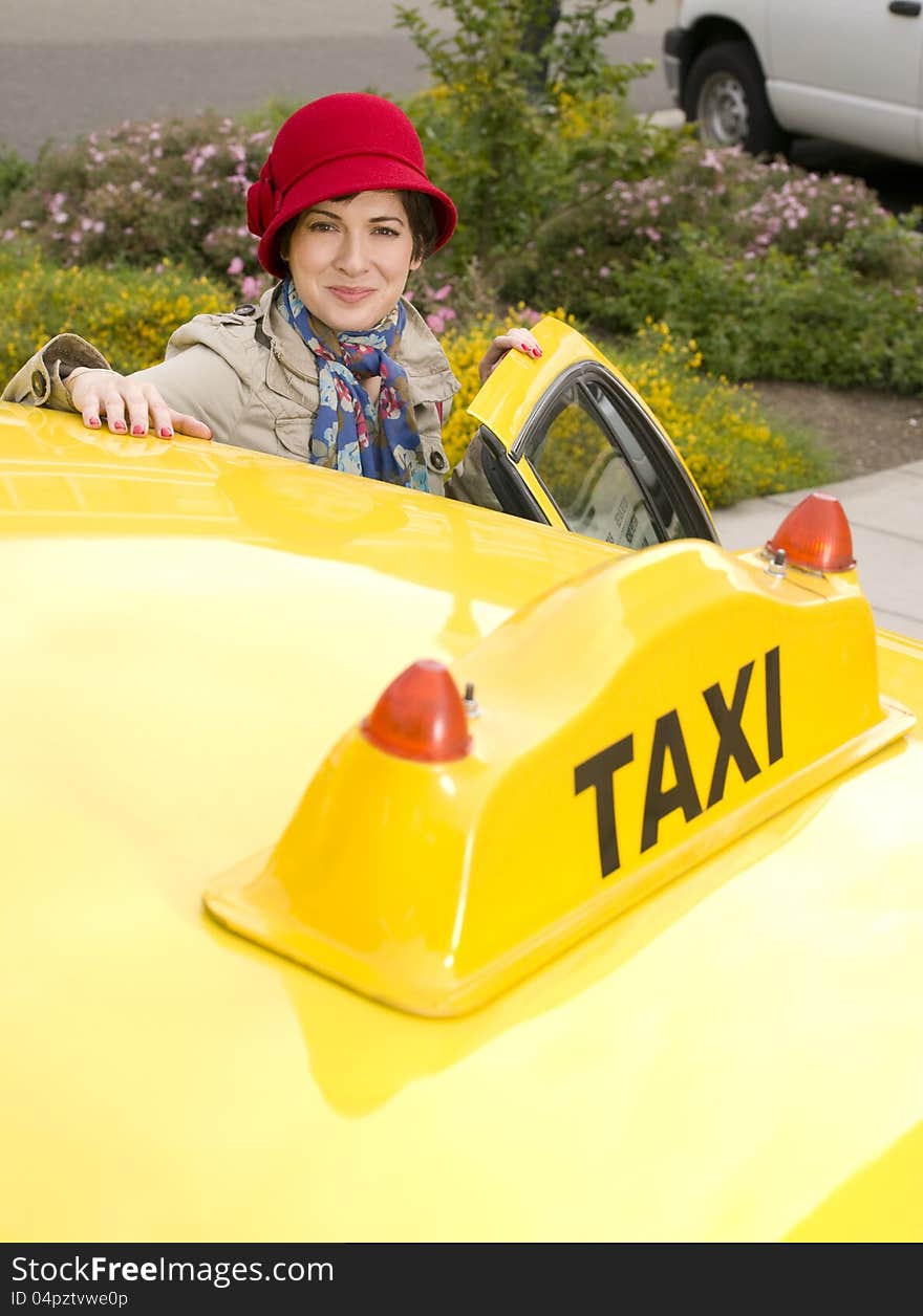 Beautiful woman enters a yellow taxi. Beautiful woman enters a yellow taxi