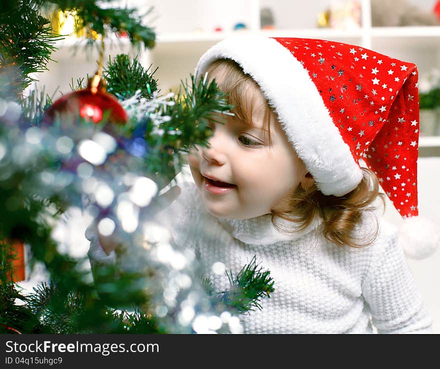 Portrait of a beautiful girl on a background of the Christmas tree. Portrait of a beautiful girl on a background of the Christmas tree