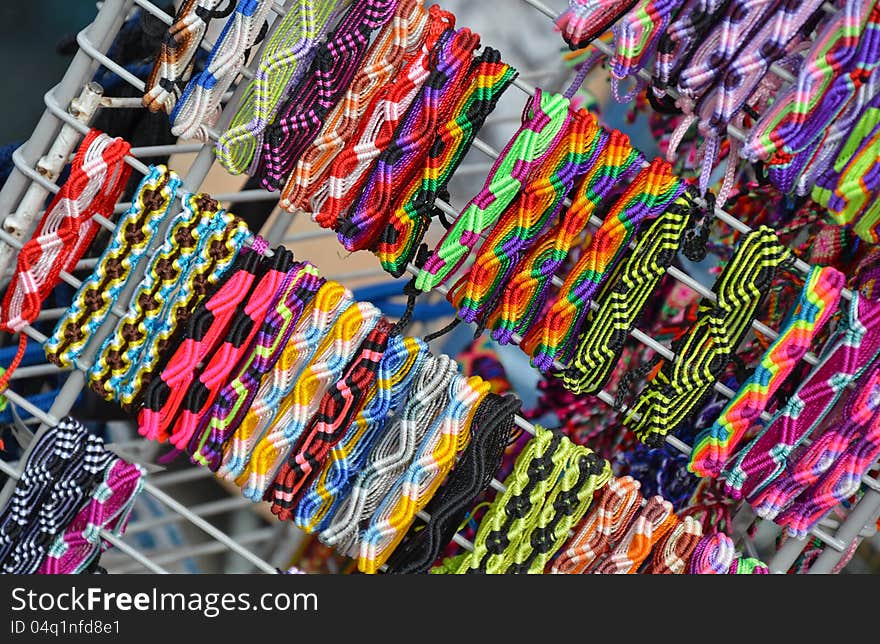 Colorful woven wristbands on display at market. Colorful woven wristbands on display at market