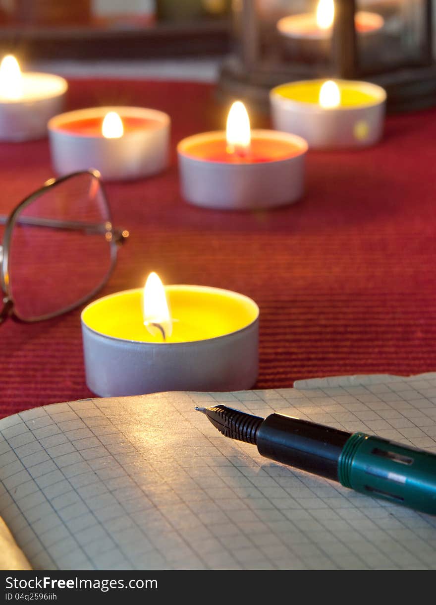 An open old book by the candlelight,close up photo