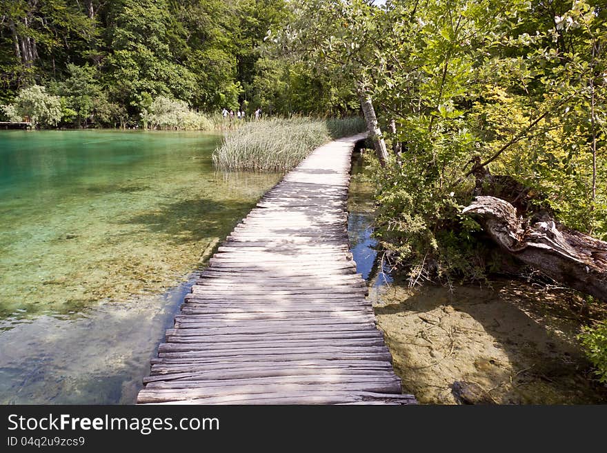 Wooden narrow pathway on the lakes in Plitvice, Croatia, Europe. Wooden narrow pathway on the lakes in Plitvice, Croatia, Europe.