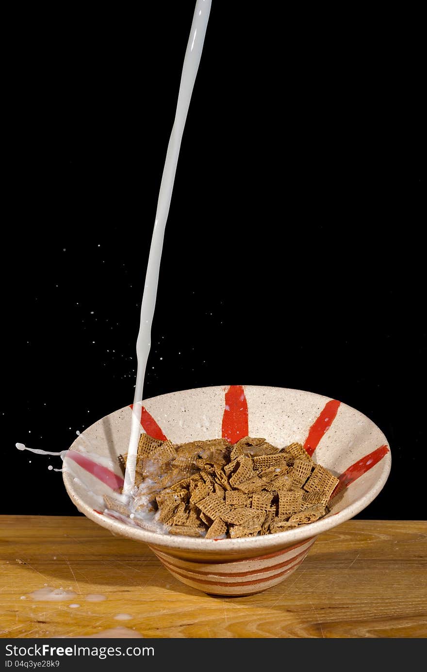 Milk splashing over a bowl of cereal. Milk splashing over a bowl of cereal