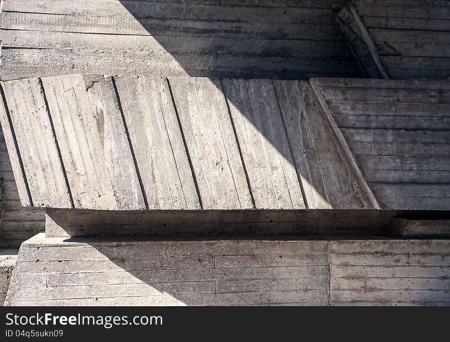 Abstract geometric concrete background illuminated by sun