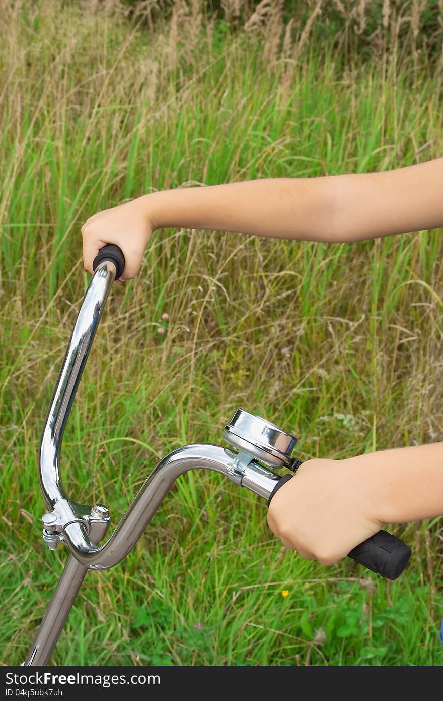 Bicycle wheel in hands at the child. Closeup