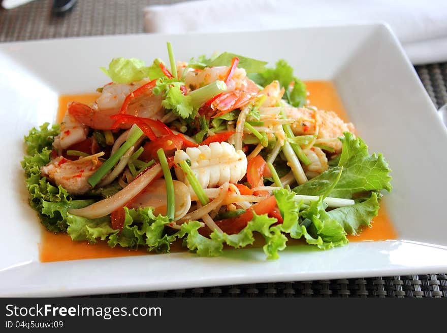 Seafood salad in the white plate rectangle. Seafood salad in the white plate rectangle